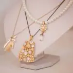 Luxury gold jewelry on set holders and in jewelry box on light dressing table and wardrobe shelves